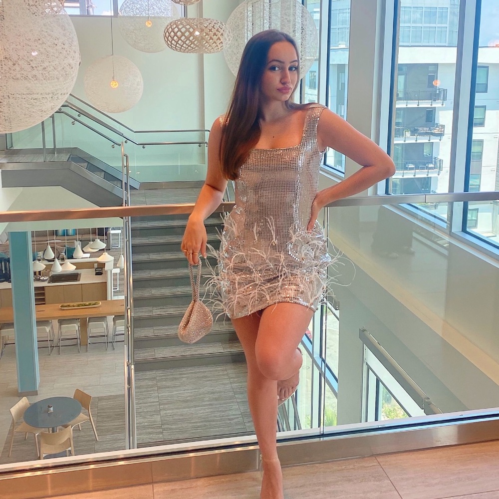 Silver sparkly mini dress with feathers disco vibe
